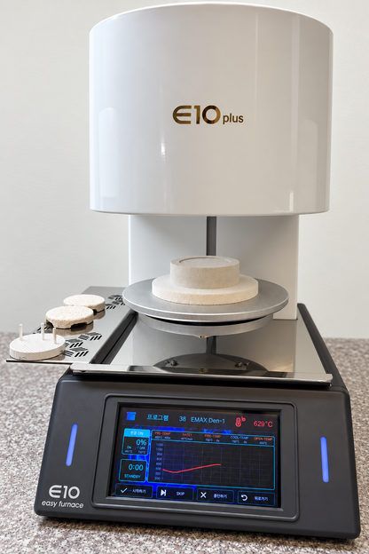 E10 Plus dental porcelain furnace with ceramic firing tray on its open platform in a lab workspace